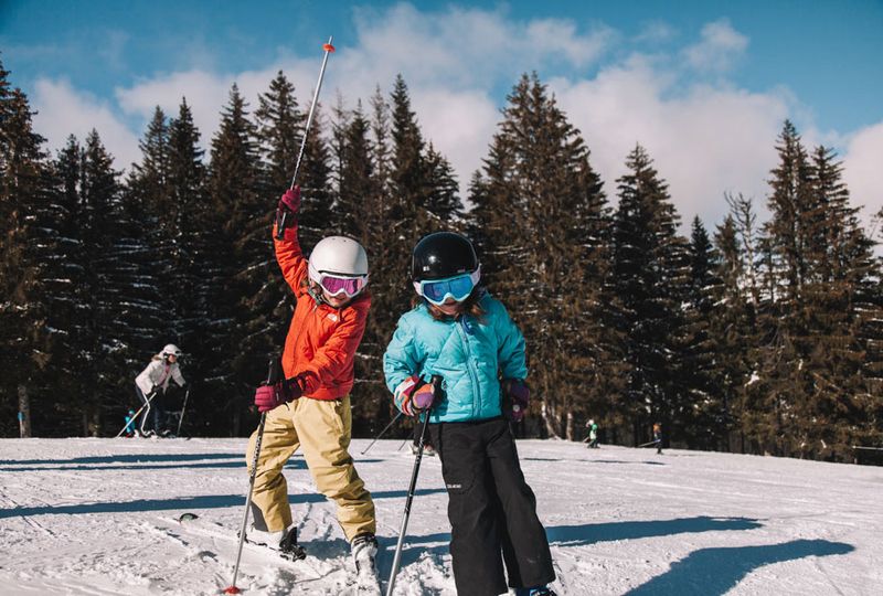 Kids posing on the ski slope