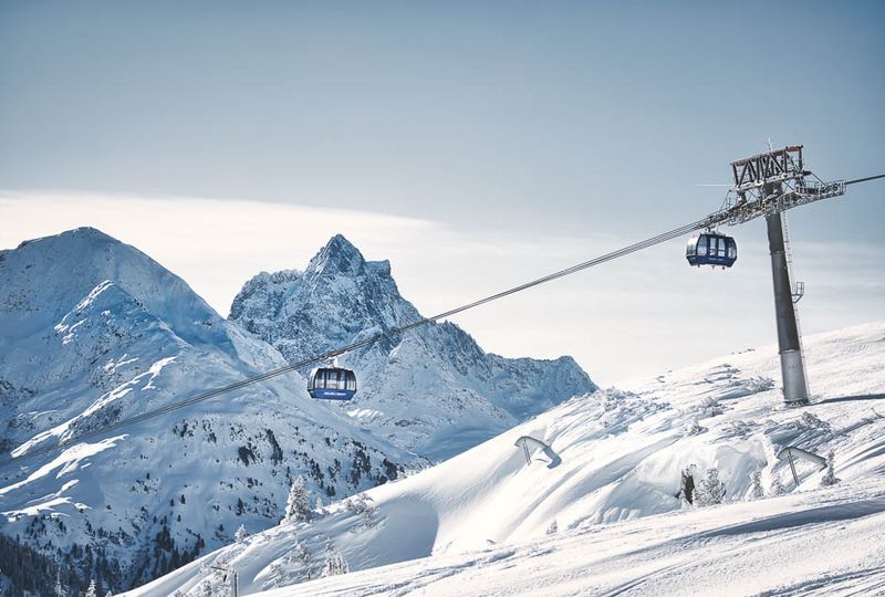 Gondolas in St Anton against a seriously stunning backdrop of a huge snow-covered mountain