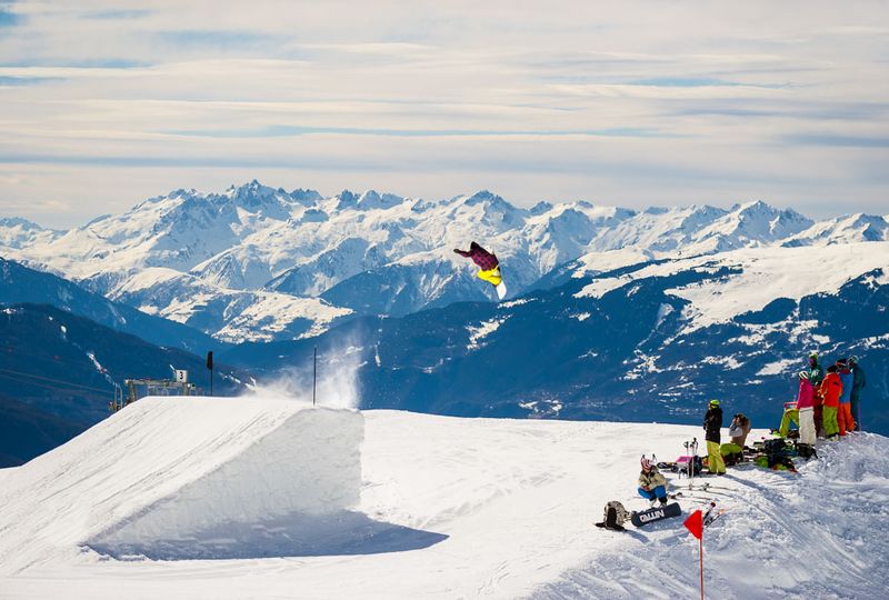 A freestyle skier pulls a trick off a huge kicker in the snowpark