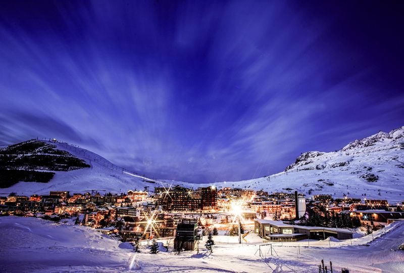 An alpine village lit up at night