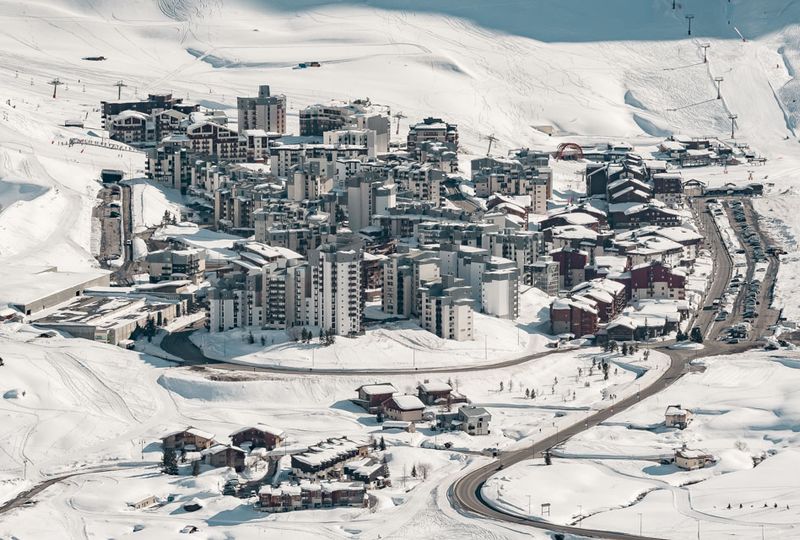 A bird's eye view of the purpose-build resort village of Tignes under snow